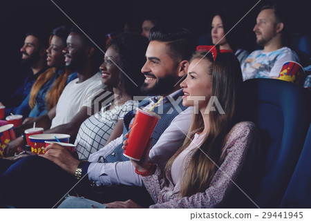 Group of people watching movie in modern cinema Group of people watching movie in modern cinema 29441945