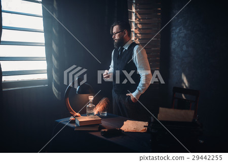 Bearded writer in glasses smoking a cigarette Bearded writer in glasses smoking a cigarette 29442255