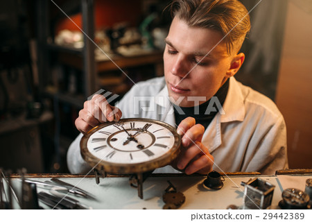 Watchmaker adjusts the mechanism of old watches 29442389