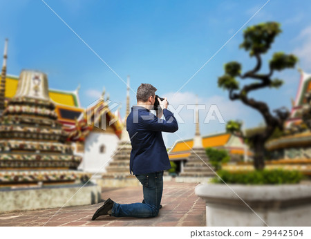 Male camerist taking picture of the temple Male camerist taking picture of the temple 29442504