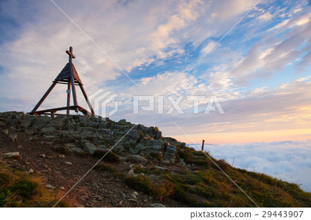 Wooden monument at sunrise.Austria. Wooden monument at sunrise.Austria. 29443907