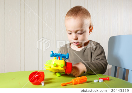 little boy repairs auto 29445359