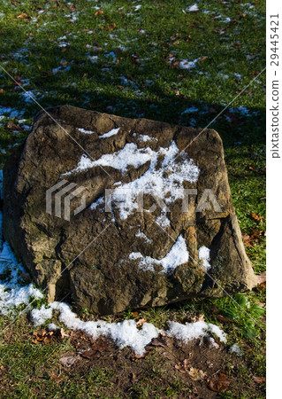Rock found on green grass background Rock found on green grass background 29445421