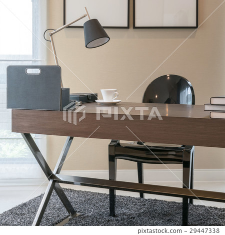 wooden table and books in modern working room 29447338