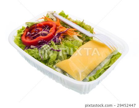 Salad with dressing in plastic container isolated  29452447