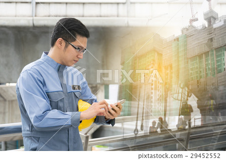 engineer using his smartphone engineer using his smartphone 29452552