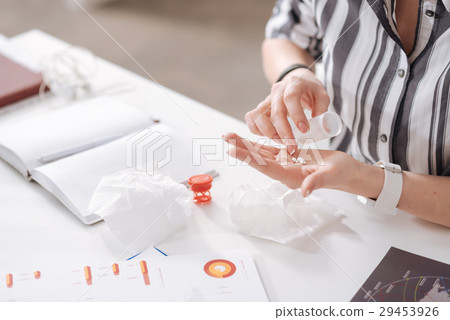 Female fingers counting medicine on the palm 29453926