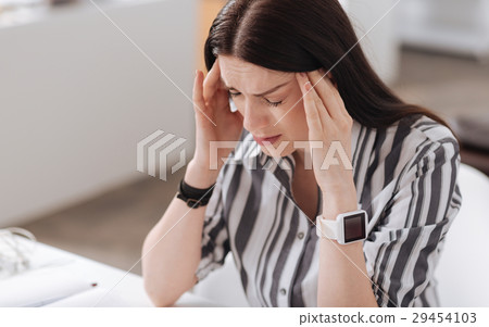 Inactive young woman having terrible headache 29454103