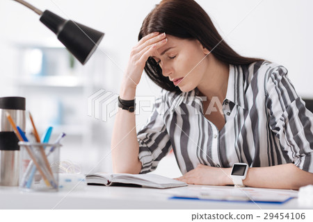 Excited female leaning her head on right hand 29454106