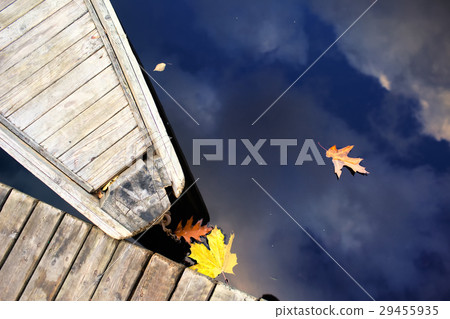 Nose of wooden boat at the pier and leaves Nose of wooden boat at the pier and leaves 29455935