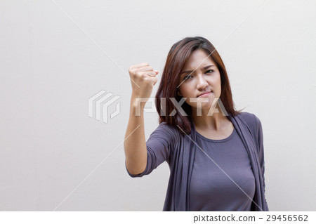angry and aggressive woman raising her fist 29456562