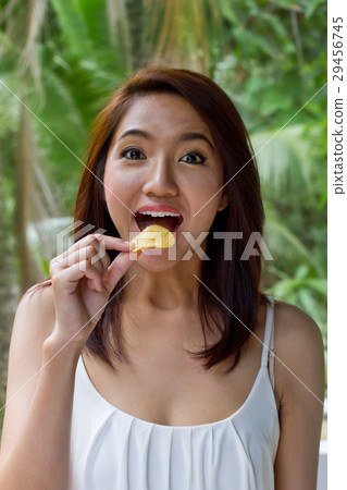woman eating fried potato chip, unhealthy food 29456745