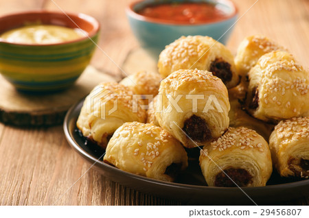 Homemade sausage rolls on wooden background. 29456807