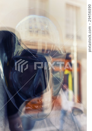 Reflection of the city in a mannequin in a window 29456890