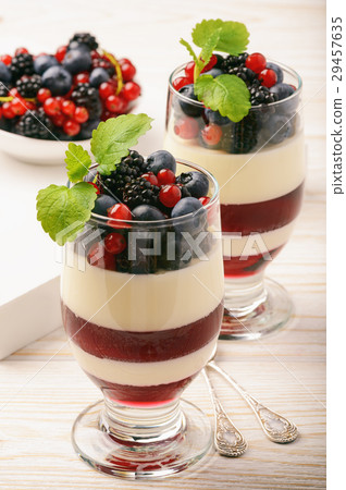 Panna cotta with berry jelly and berries. 29457635