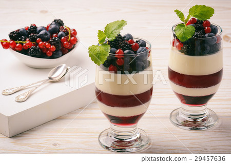 Panna cotta with berry jelly and berries. 29457636