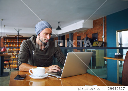 Young handsome hipster man with beard is using Young handsome hipster man with beard is using 29459827
