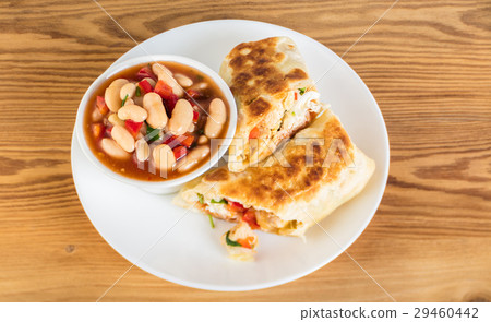 Mexican cuisine, burrito with garnish of beans 29460442