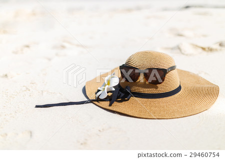 Glasses and a hat with frangipani flower. Glasses and a hat with frangipani flower. 29460754