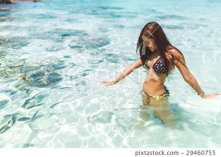 girl enjoying and playing with the water. 29460755