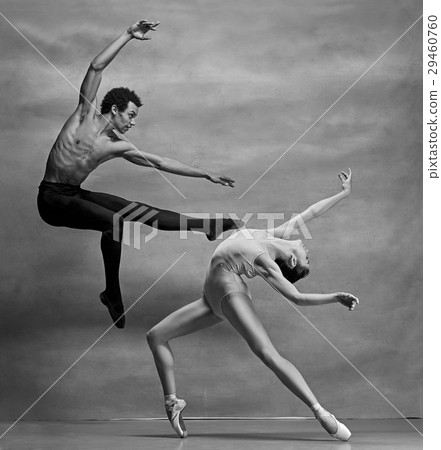 Couple of ballet dancers posing over gray Couple of ballet dancers posing over gray 29460760