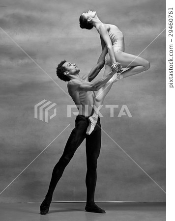 Couple of ballet dancers posing over gray Couple of ballet dancers posing over gray 29460761