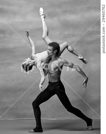 Couple of ballet dancers posing over gray 29460762