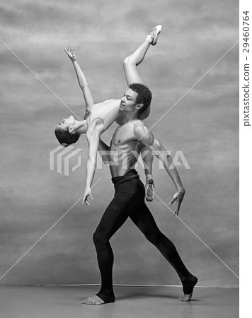 Couple of ballet dancers posing over gray Couple of ballet dancers posing over gray 29460764