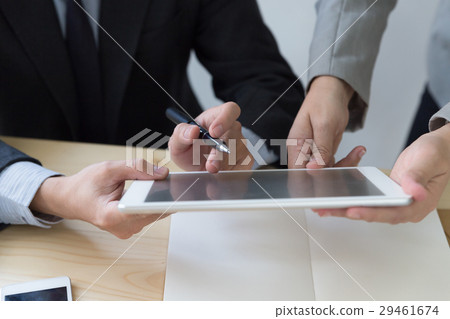 Businessman using a digital tablet to discuss Businessman using a digital tablet to discuss 29461674