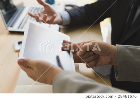 Businessman using a digital tablet to discuss Businessman using a digital tablet to discuss 29461676