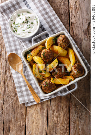 Baked meat balls with potato wedges and sour cream Baked meat balls with potato wedges and sour cream 29462893