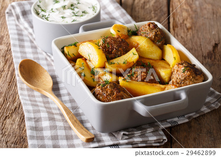 Potato wedges and meatballs, herbs in a dish 29462899