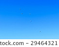 Paratroopers descend to earth on blue clear sky 29464321