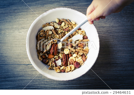 bowl with muesli and spoon on the wooden table  29464631