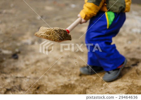 child play with sand and red shovel child play with sand and red shovel 29464636