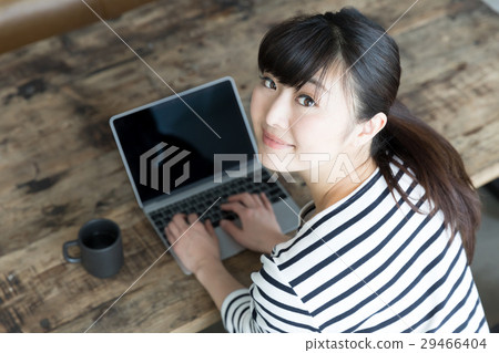 A woman working in a cafe A woman working in a cafe 29466404