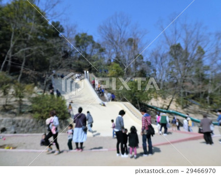 Families playing on a big slide 29466970