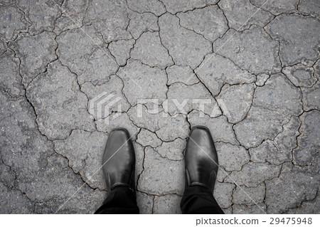 Black shoes standing on damaged concrete floor Black shoes standing on damaged concrete floor 29475948