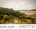 sandy beach with low tide puddles and rocky 29477732