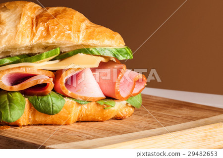 Croissants sandwiches on the wooden cutting board Croissants sandwiches on the wooden cutting board 29482653