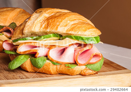 Croissants sandwiches on the wooden cutting board Croissants sandwiches on the wooden cutting board 29482664