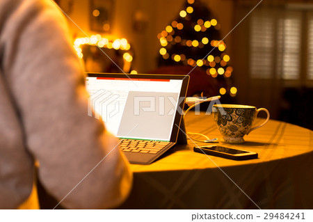 Businesswoman working on laptop on Christmas time Businesswoman working on laptop on Christmas time 29484241