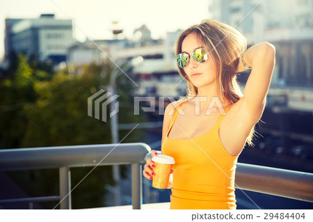 Young Fashion Woman with Coffee to Go in the City 29484404