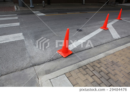 Orange roadwork cones on the asphalt road. 29484476