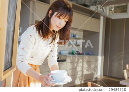 A young Japanese woman working in a cafe A young Japanese woman working in a cafe 29484838