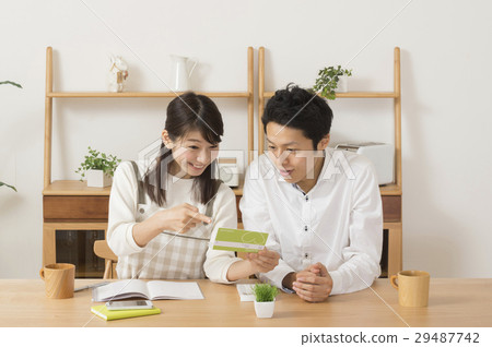 Spouses delighted while looking at their passbook Extraordinary income Benefit refund 29487742