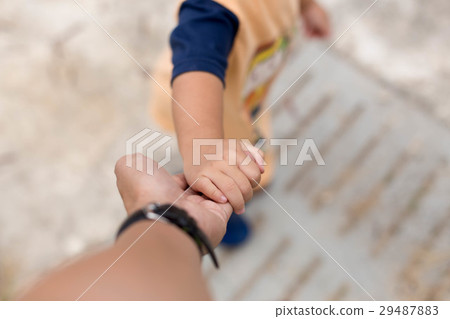 Little child holding her father is hand 29487883