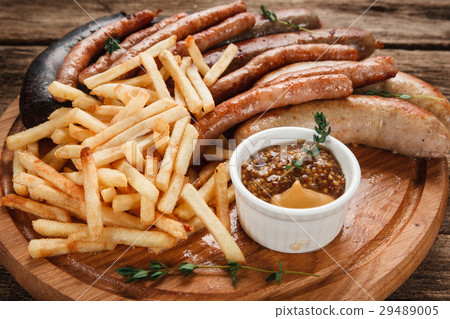 Fresh grilled sausage mix on wood platter close up Fresh grilled sausage mix on wood platter close up 29489005