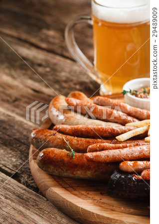 Appetizing grill sausages and light beer, close up 29489009