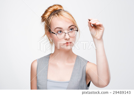 Young girl writing or drawing on screen with pen 29489143